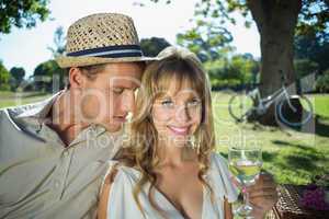 Cute couple drinking white wine on a picnic woman smiling at cam