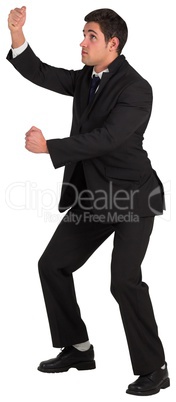 Young businessman standing and pulling