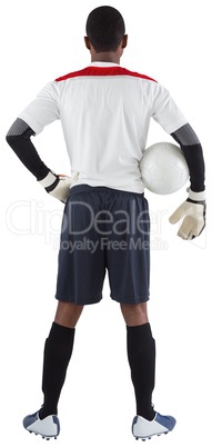 Goalkeeper in white holding ball