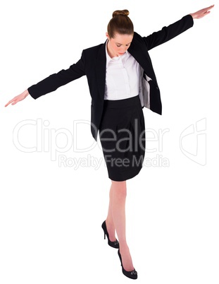 Businesswoman performing a balancing act