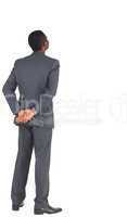 Businessman standing with hands behind back