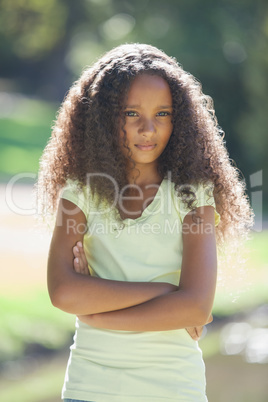 Young girl frowning with arms crossed in the park Young girl frowning with arms crossed in the park