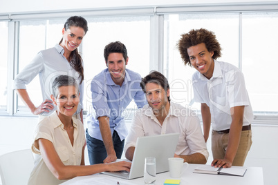 Business people working on laptop smile to camera