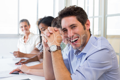 Casual businessman laughing during meeting