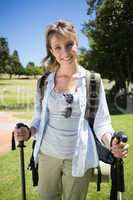 Fit smiling woman going for a hike