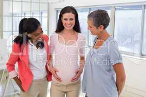 Attractive pregnant businesswoman at work
