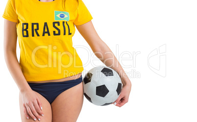 Fit girl in bikini and brasil tshirt holding ball