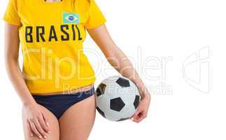 Fit girl in bikini and brasil tshirt holding ball