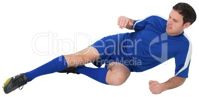 Football player in blue kicking