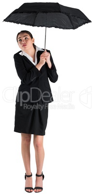 Young businesswoman holding umbrella