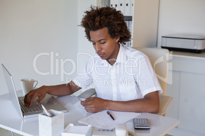 Relaxed casual businessman shopping online at his desk