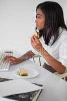 Pretty businesswoman having a sandwich at her desk