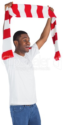 Happy football fan waving scarf