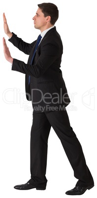 Businessman in suit pushing with hands