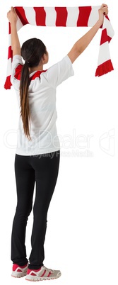 Football fan waving red and white scarf