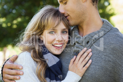 Cute woman smiling at camera with her boyfriend
