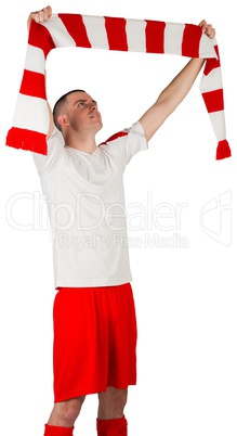 Football player holding striped scarf