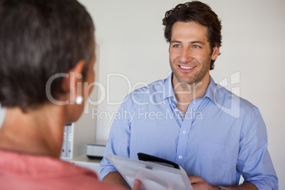 Casual smiling businessman looking at colleague