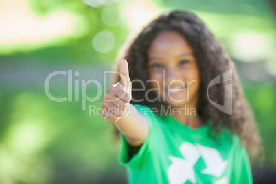 Young environmental activist smiling at the camera showing thumb