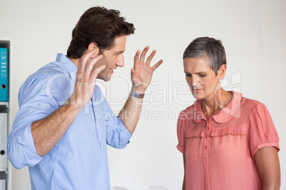 Angry businessman shouting at employee