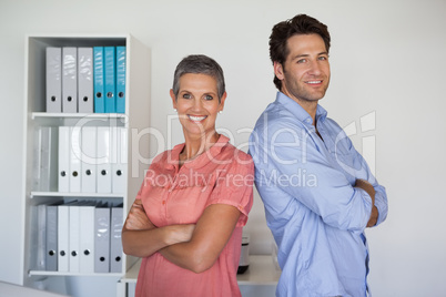 Casual smiling business team standing back-to-back