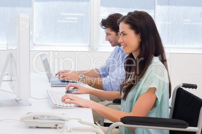 Worker in wheelchair working on computer