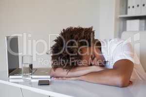 Casual businessman sleeping at his desk