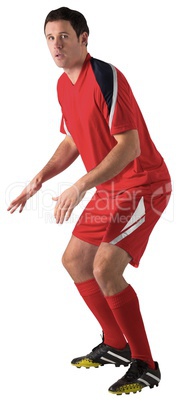 Football player in red standing ready