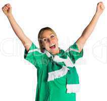 Cheering football fan in green jersey