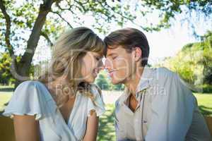 Cute couple sitting outside at a cafe head to head