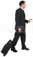 Businessman pulling his suitcase holding coffee