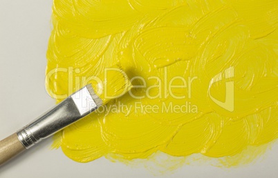 Yellow paint with paintbrush