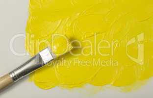 Yellow paint with paintbrush