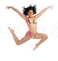 Fit girl in bikini leaping and smiling at camera