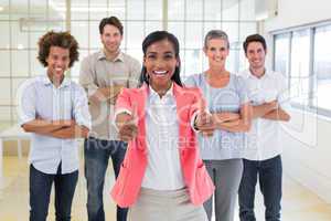 Happy team of workers giving thumbs up