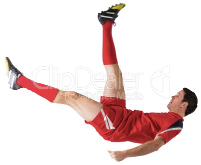 Football player in red kicking