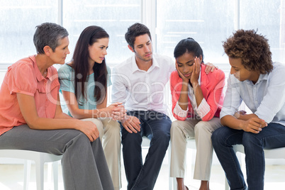 Group therapy in session sitting in a circle