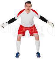 Goalkeeper in white ready to save