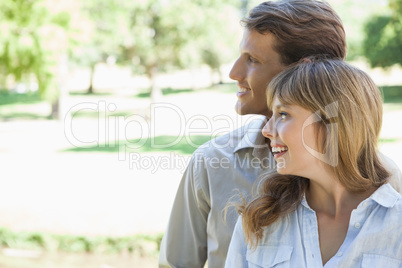 Carefree couple standing in the park and smiling