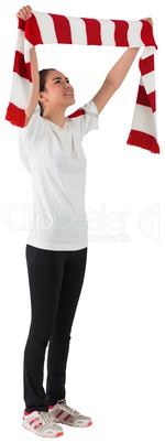 Football fan waving red and white scarf