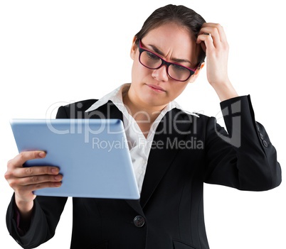 Thinking businesswoman looking at tablet pc