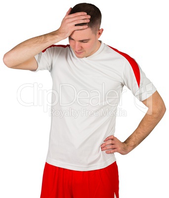 Disappointed football player looking down