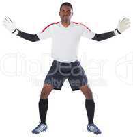 Goalkeeper in white ready to save