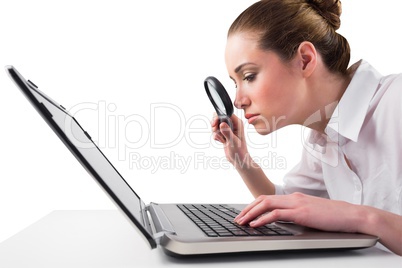 Attentive businesswoman typing on laptop