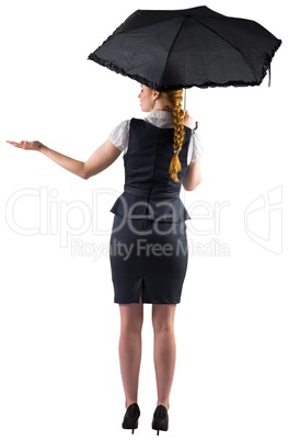 Pretty redhead businesswoman holding umbrella