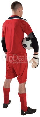 Goalkeeper in red holding the ball