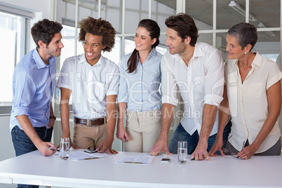 Casual business team having a meeting standing