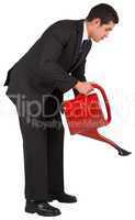 Businessman watering with red can