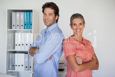 Casual smiling business team standing back-to-back