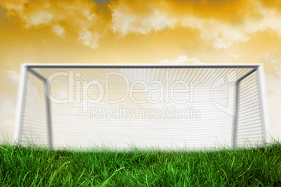 Goalpost on grass under yellow sky